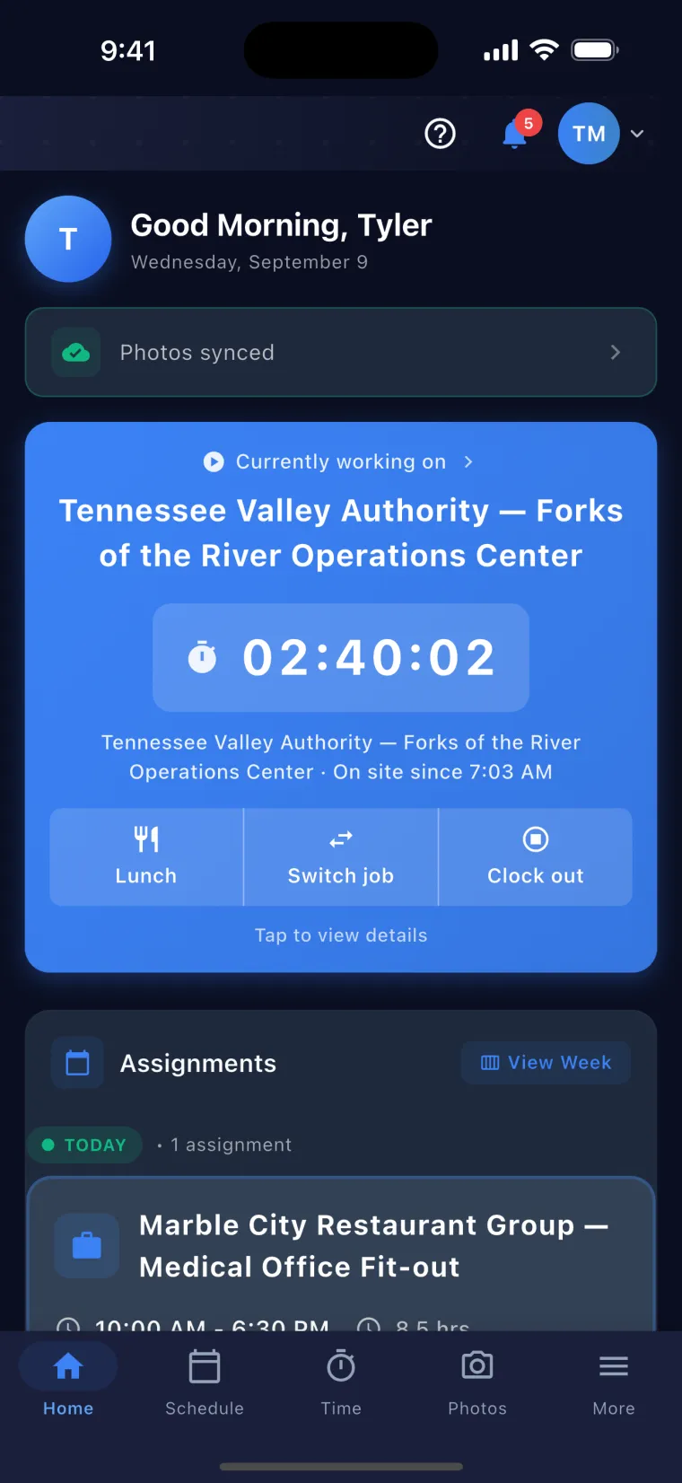 JobSiteCore field crew home — the running clock-in card for the job the worker is standing on, with its live timer, the time they came on site and Lunch, Switch job and Clock out beneath it, above today's dated assignment